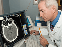 Doctor looking at a brain scan on the computer